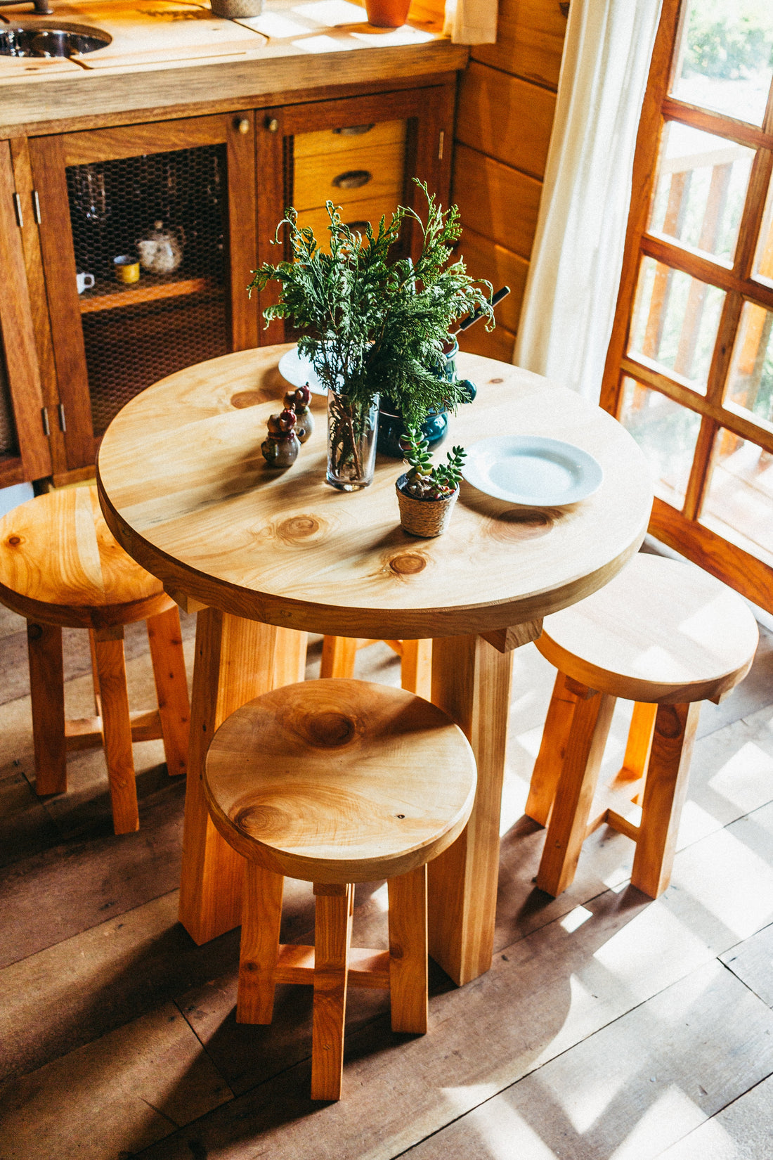 wooden table and chairs, with plants as a center piece